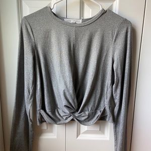 Grey long sleeve. Cute front detail. Cropped fit